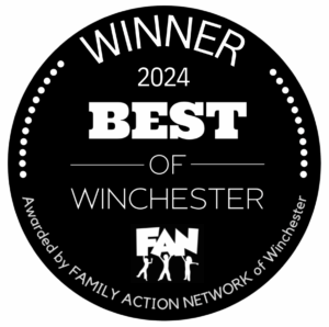 Black circular award logo reading "Winner 2024 Best of Winchester," with "FAN" and text stating "Awarded by Family Action Network of Winchester, recognizing top-notch salons for excellence in service and client satisfaction.